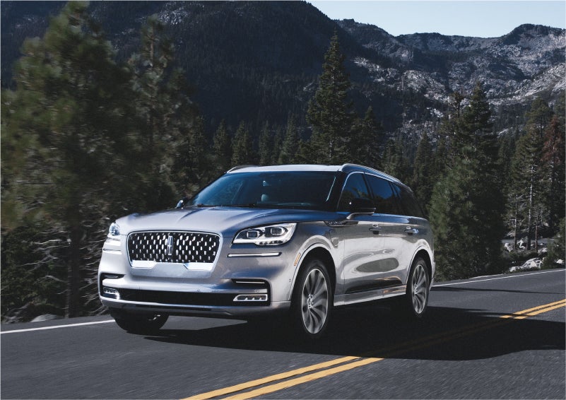A 2023 Lincoln Aviator® Grand Touring SUV being driven on a winding road to demonstrate the capabilities of all-wheel drive | Jenkins & Wynne Lincoln in Clarksville TN