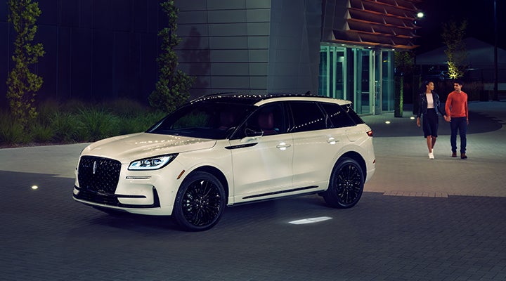 Two people approach a 2024 Lincoln Corsair® SUV featuring the available Jet Appearance Package. | Jenkins & Wynne Lincoln in Clarksville TN