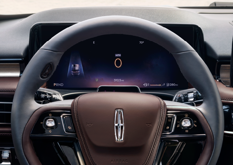 The steering wheel of 2025 Lincoln Aviator® SUV is shown with black and brown accents. | Jenkins & Wynne Lincoln in Clarksville TN