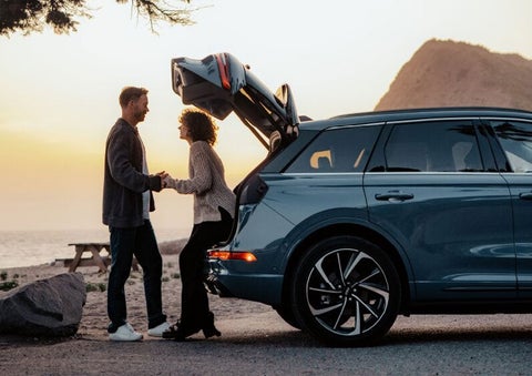 A couple share a moment together outside a 2025 Lincoln Corsair® SUV near the open liftgate. | Jenkins & Wynne Lincoln in Clarksville TN