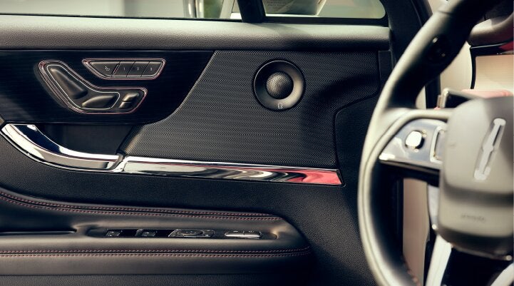 A Revel® audio speaker is shown in the driver's side door of a 2025 Lincoln Corsair® SUV. | Jenkins & Wynne Lincoln in Clarksville TN