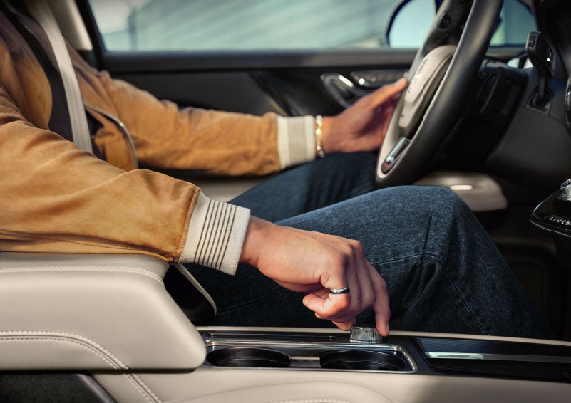 The driver of a 2024 Lincoln Corsair® SUV is shown selecting the drive mode. | Jenkins & Wynne Lincoln in Clarksville TN