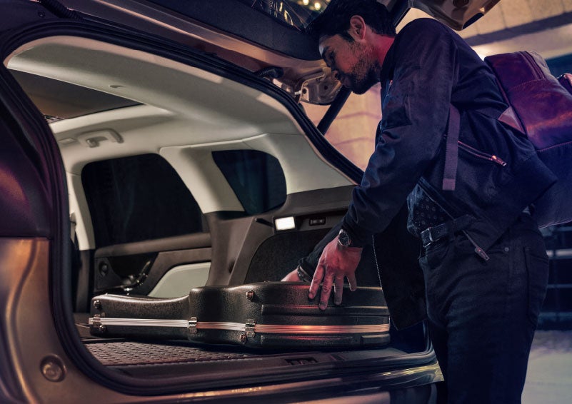 A man is shown loading cargo into the rear of a 2024 Lincoln Corsair® SUV with the second-row seats folded flat. | Jenkins & Wynne Lincoln in Clarksville TN