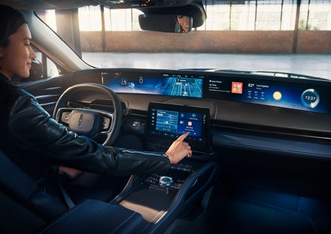The driver of a 2025 Lincoln Nautilus® SUV interacts with the center touchscreen. | Jenkins & Wynne Lincoln in Clarksville TN