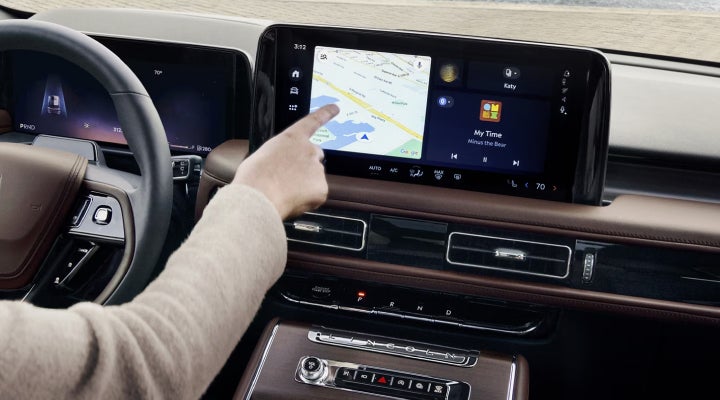 A person is tapping the center display touchscreen of a 2026 Lincoln Aviator® SUV. | Jenkins & Wynne Lincoln in Clarksville TN