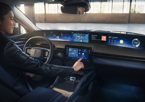 The driver of a 2026 Lincoln Nautilus® SUV interacts with the center touchscreen. | Jenkins & Wynne Lincoln in Clarksville TN